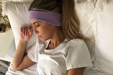 Woman who is a light sleeper uses SleepPhones for better sleep.