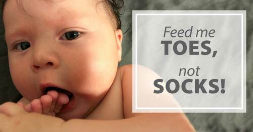 feed me toes, not socks: baby putting toes in mouth