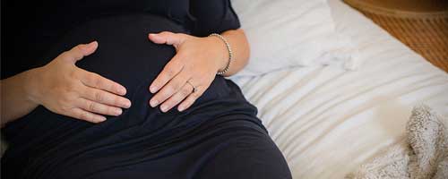 woman holding pregnant belly