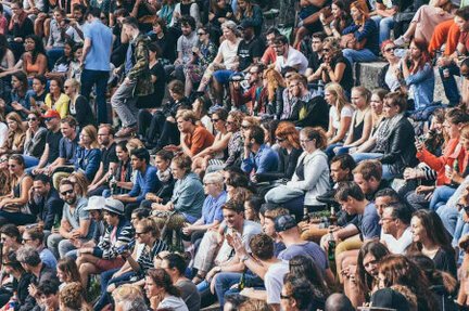 Crowd of people sitting in packed stadium