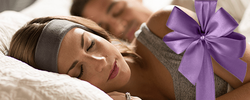 SleepPhones are the ideal gift. Purple bow and woman sleeping with flat, gray sleep headphones.