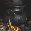 a boiling cauldron on a fire