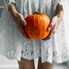 pumpkin against a creepy dress