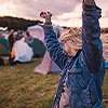 girl dancing with hands in the air at festival