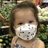 child wearing kn95 mask while grocery shopping