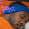 man sleeping listening to binaural beats with SleepPhones headphones