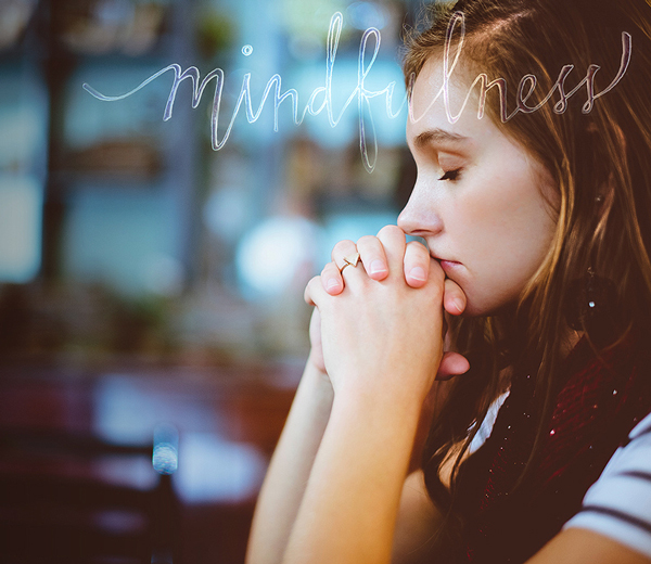 girl meditating with eyes shut