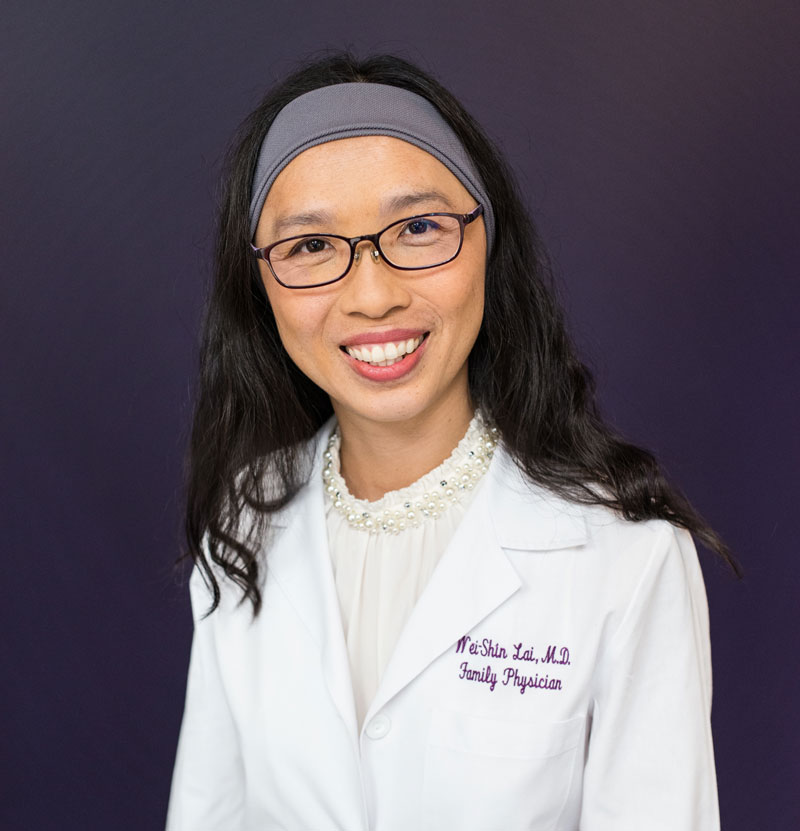 Wei-Shin Lai, MD in white lab coat and SleepPhones headphones