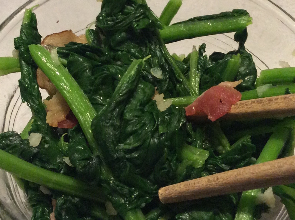 Cooked stir-fry arugula with garlic