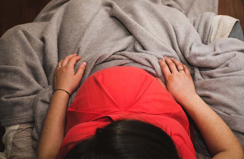 pregnant woman using sleepphones comfortable headphones for hypnobirthing