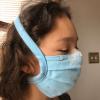 a child modeling Dr. Wei-Shin Lai's comfortable coronavirus mask design