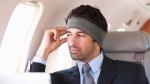 man traveling in comfort with SleepPhones® ASMR Edition headphones