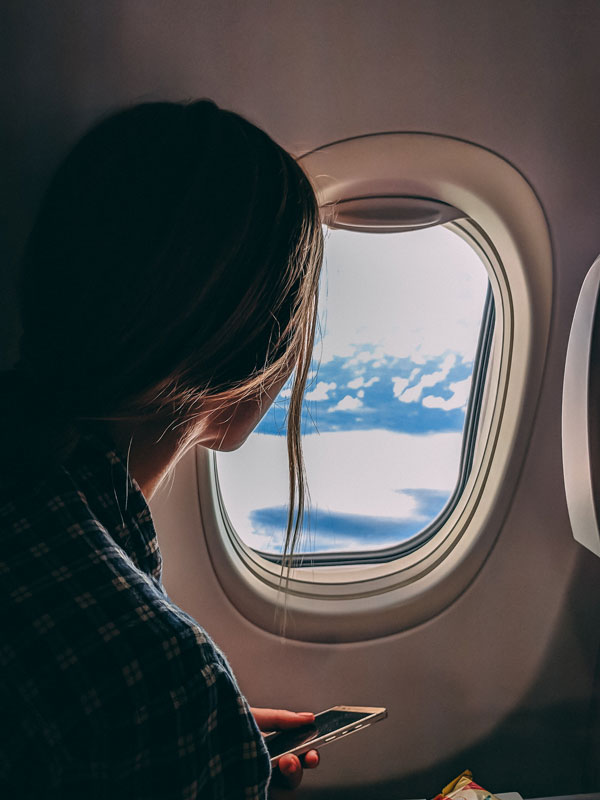 Woman looking out airplane window