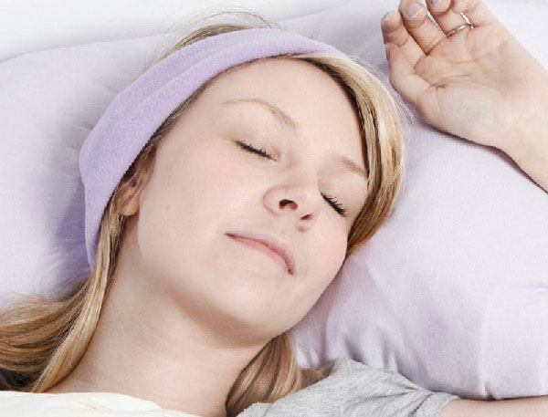 Woman sleeping in SleepPhones headband headphones for asmr